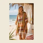 Adult beach poncho in a multicolour Anatolian print with fringed hem worn on the beach