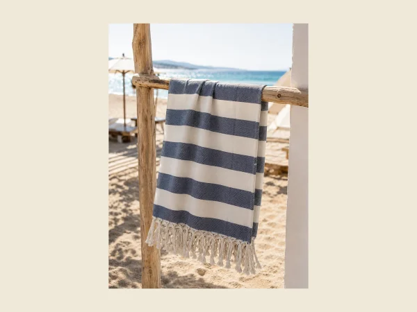 Classic flat-woven peshtemal in navy and white stripe with hand-knotted tassels — lightweight Turkish cotton
