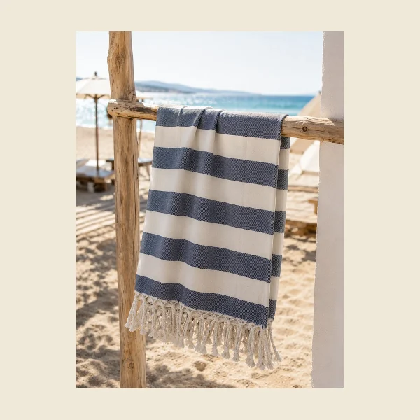 Classic flat-woven peshtemal in navy and white stripe with hand-knotted tassels — lightweight Turkish cotton