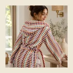 Hooded bathrobe with multicolour pompom weave and a raised hood — relaxed resort styling