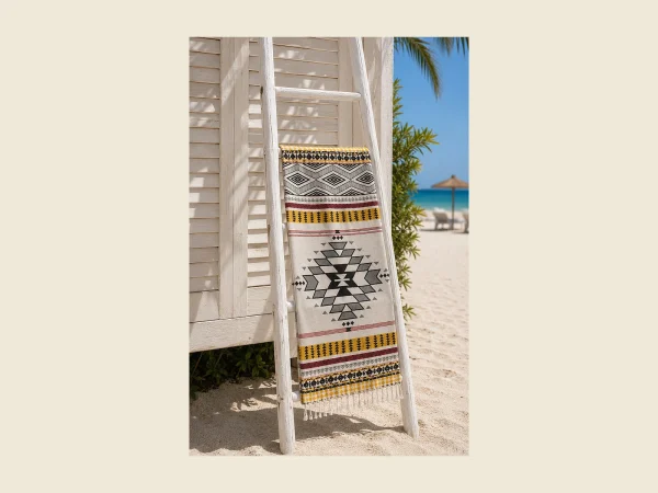 Jacquard peshtemal with a loom-woven geometric pattern displayed on a white ladder rail