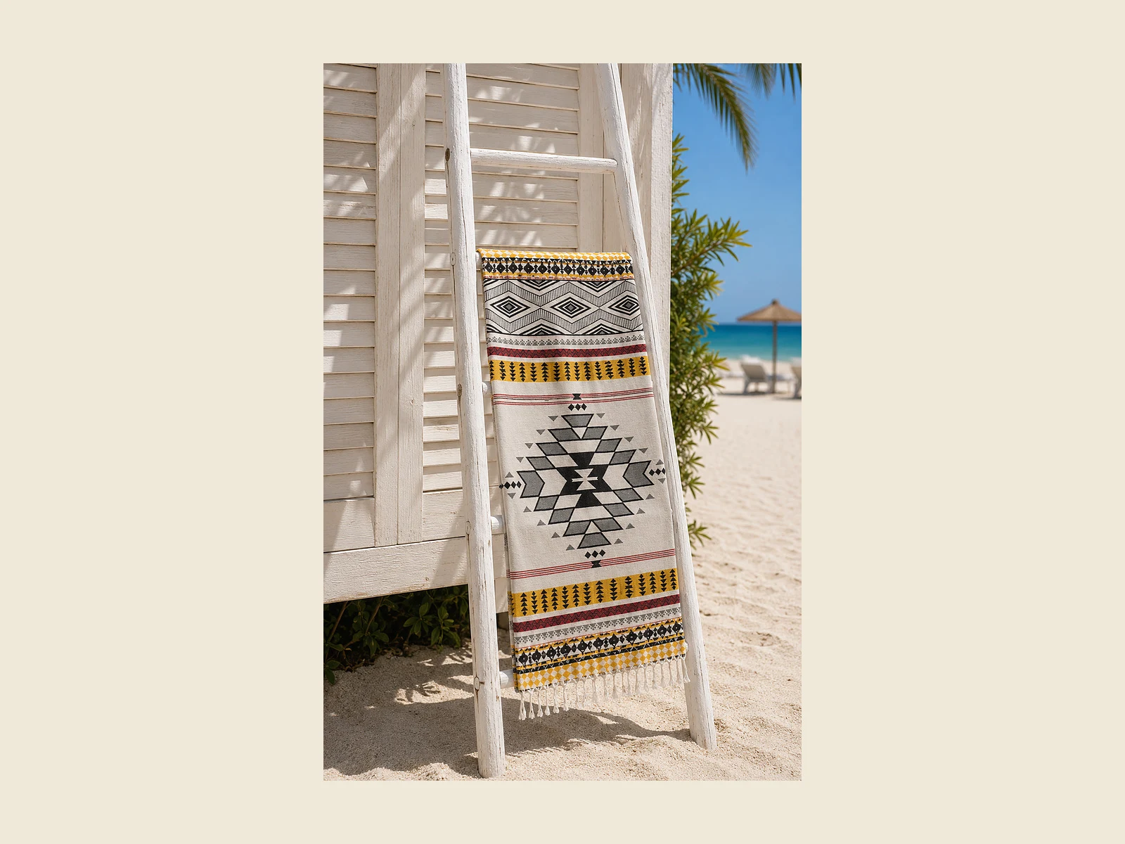 jacquard-hammam-towels Jacquard peshtemal with a loom-woven geometric pattern displayed on a white ladder rail