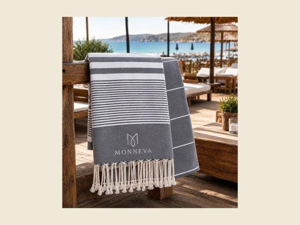 Private label peshtemal in navy and white stripe with a woven MONNEVA label and knotted fringe
